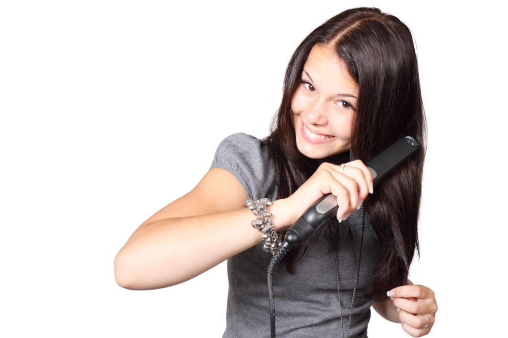 girl using a hair iron