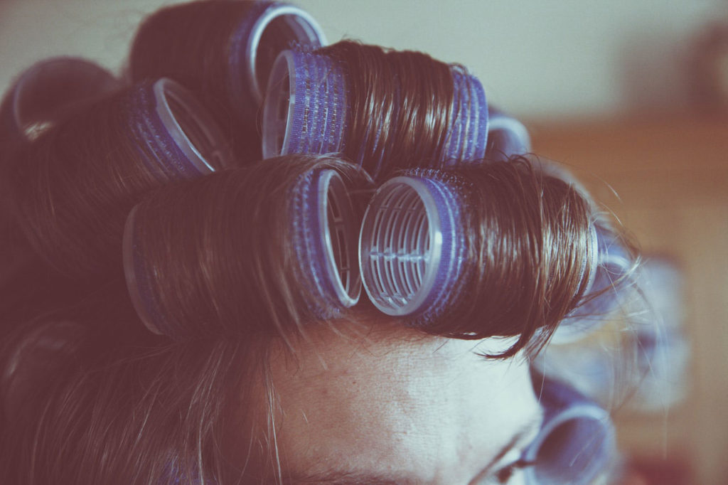 girl with rollers in her hair