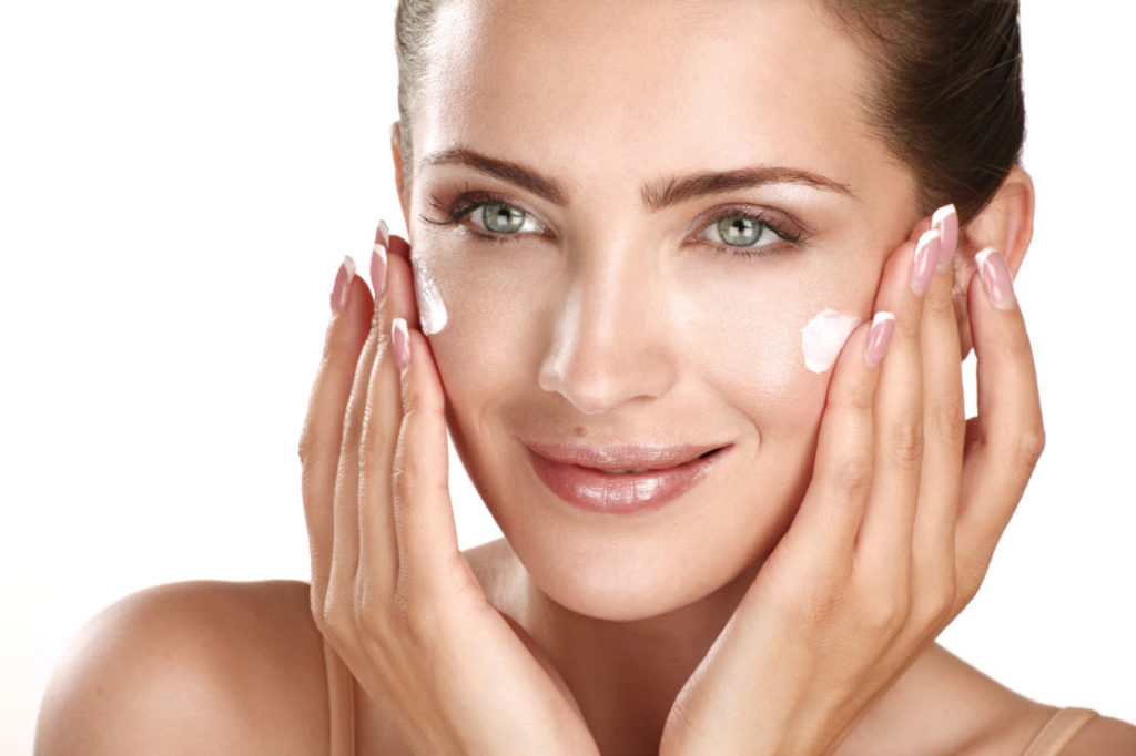 girl moisturizing her face