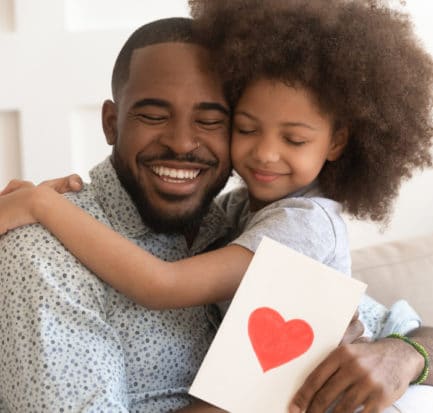 Happy Affectionate African American Dad Embracing Stock Photo
