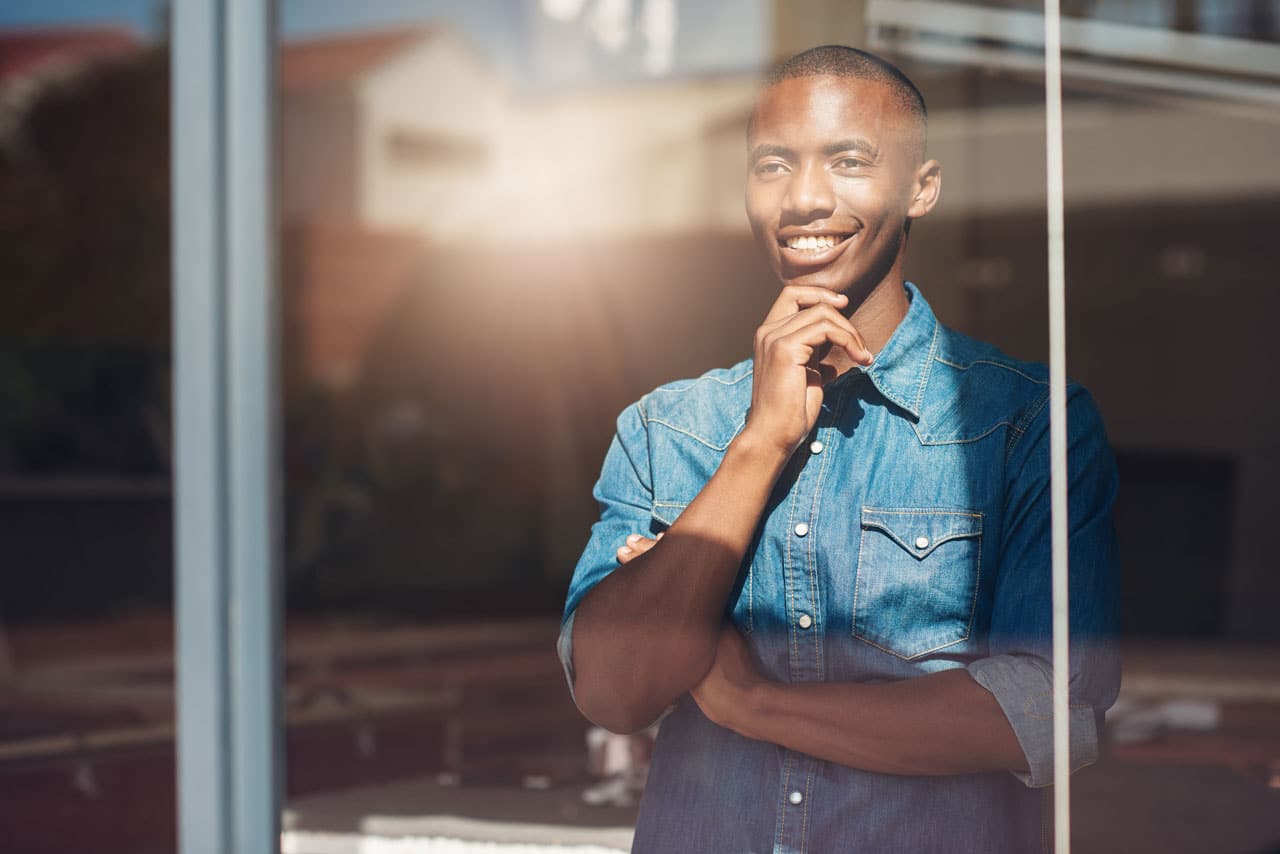 oung African Designer Looking Through Window Stock Photo