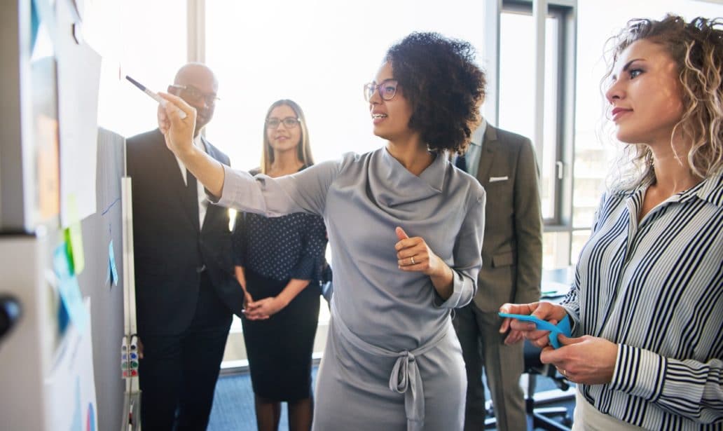Diverse Group Focused Businesspeople Brainstorming Together Stock