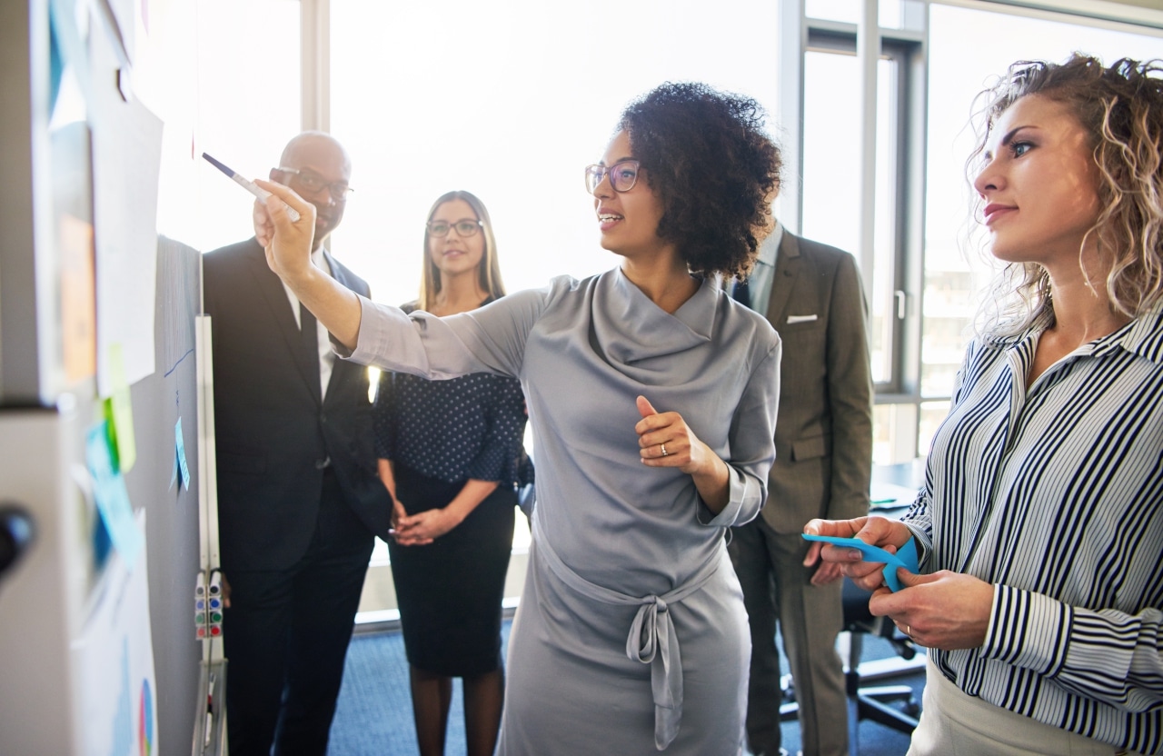 Diverse Group Focused Businesspeople Brainstorming Together Stock