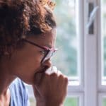 Lonely Black Woman Near Window Thinking