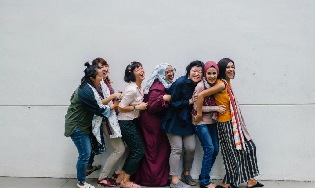 Woman Falling In Line Holding Each Other