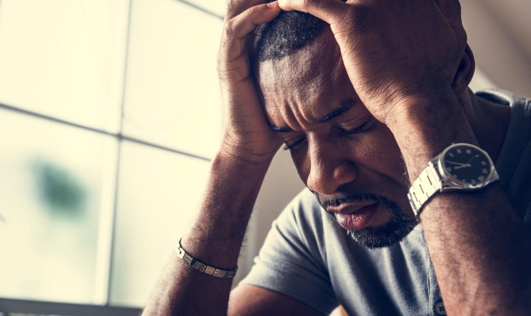 Black guy stressing and headache