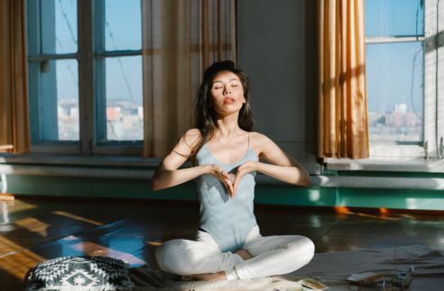 asian woman with stone practicing meditation