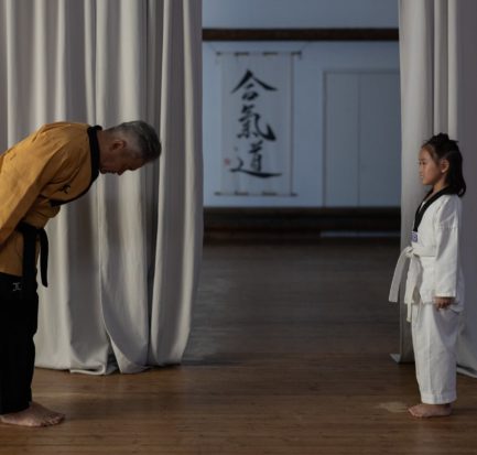 a martial arts instructor bowing to a student