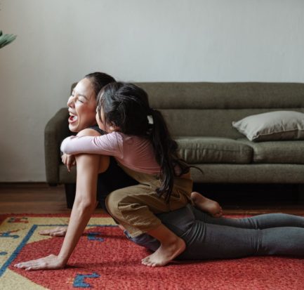 photo of girl hugging a woman while doing yoga pose