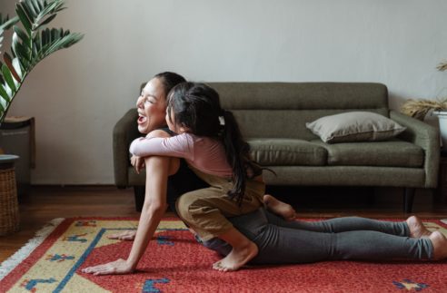 photo of girl hugging a woman while doing yoga pose