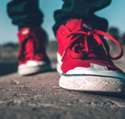 photo of person wearing red shoes