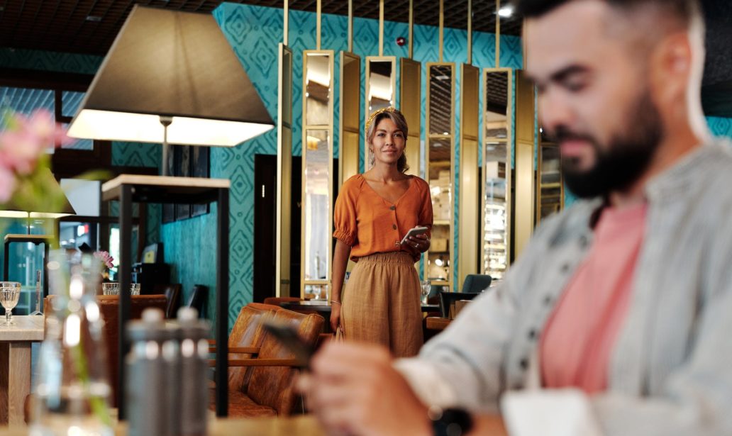 woman looking at a man sitting by the table