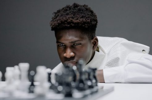 black teen playing chess