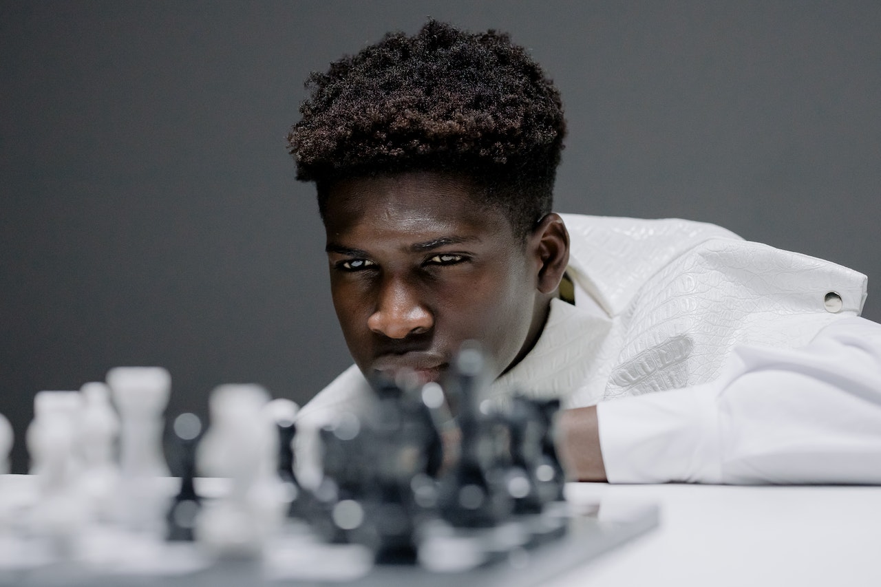 black teen playing chess