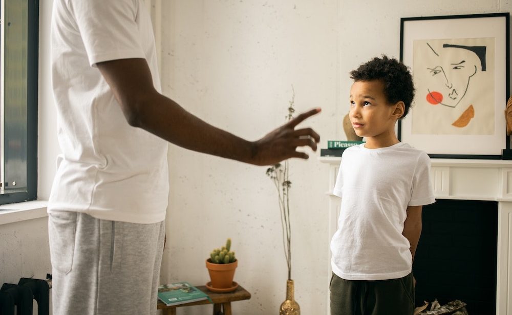 man disciplining his little boy
