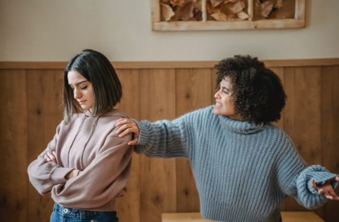 multiracial ladies having disagreement in room