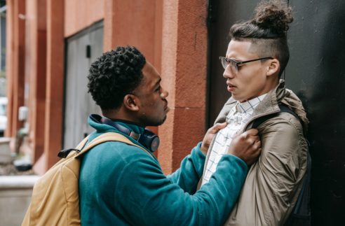 multiracial men having an argument in the street