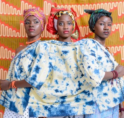 three women in a white and blue top