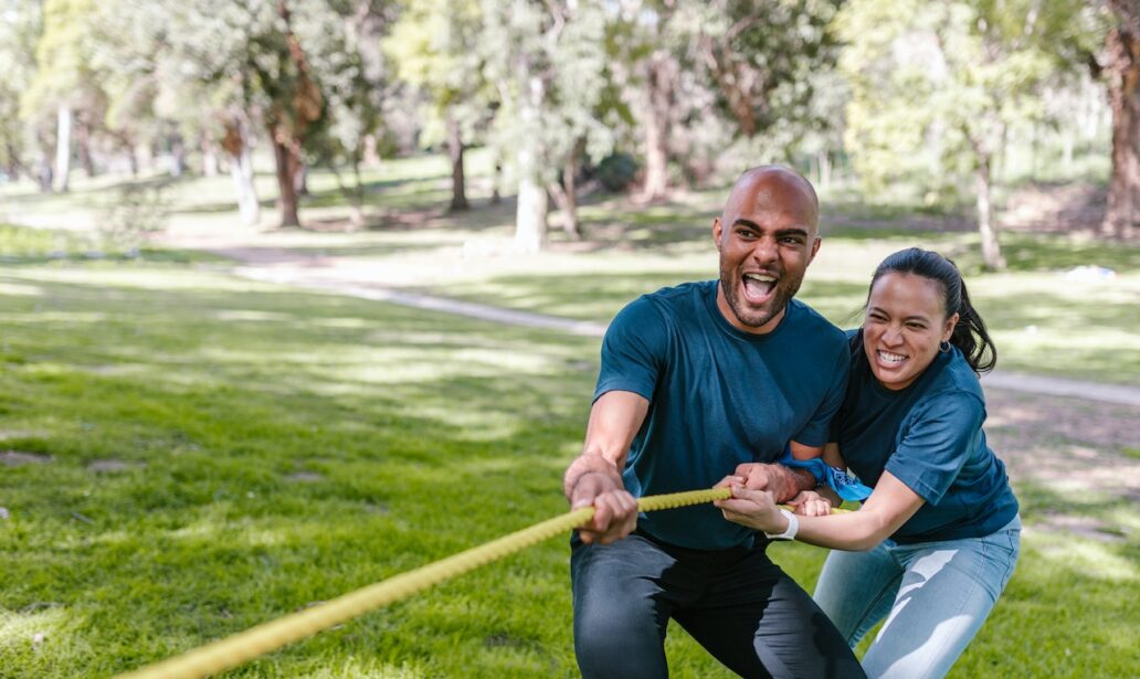 man and woman pulling a rope