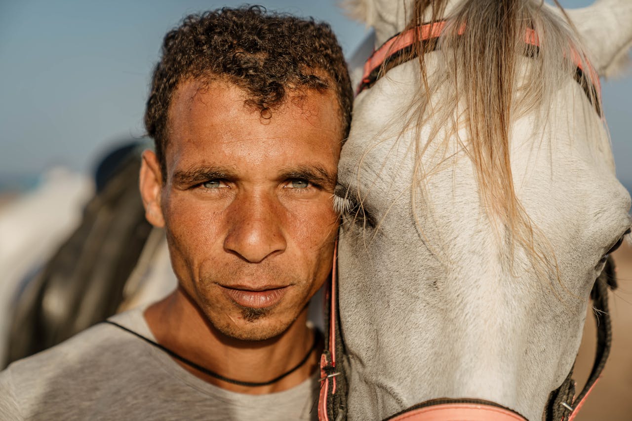 man with blue eyes and a horse