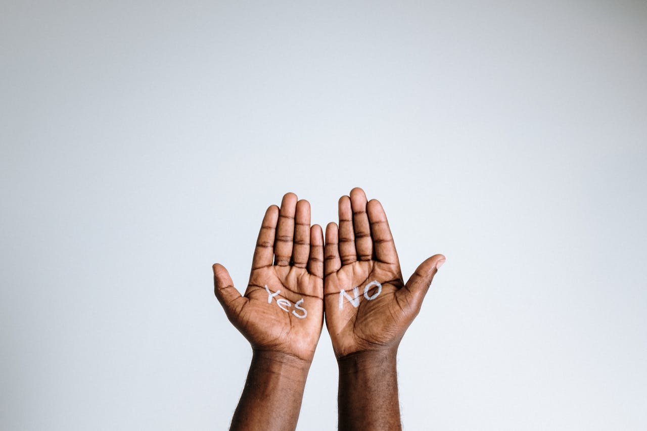 photo of person's hands with "yes" and "no" painted on them