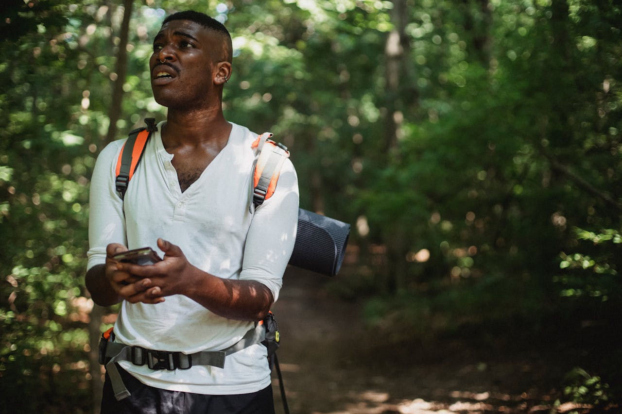 black man lost with smartphone in forest