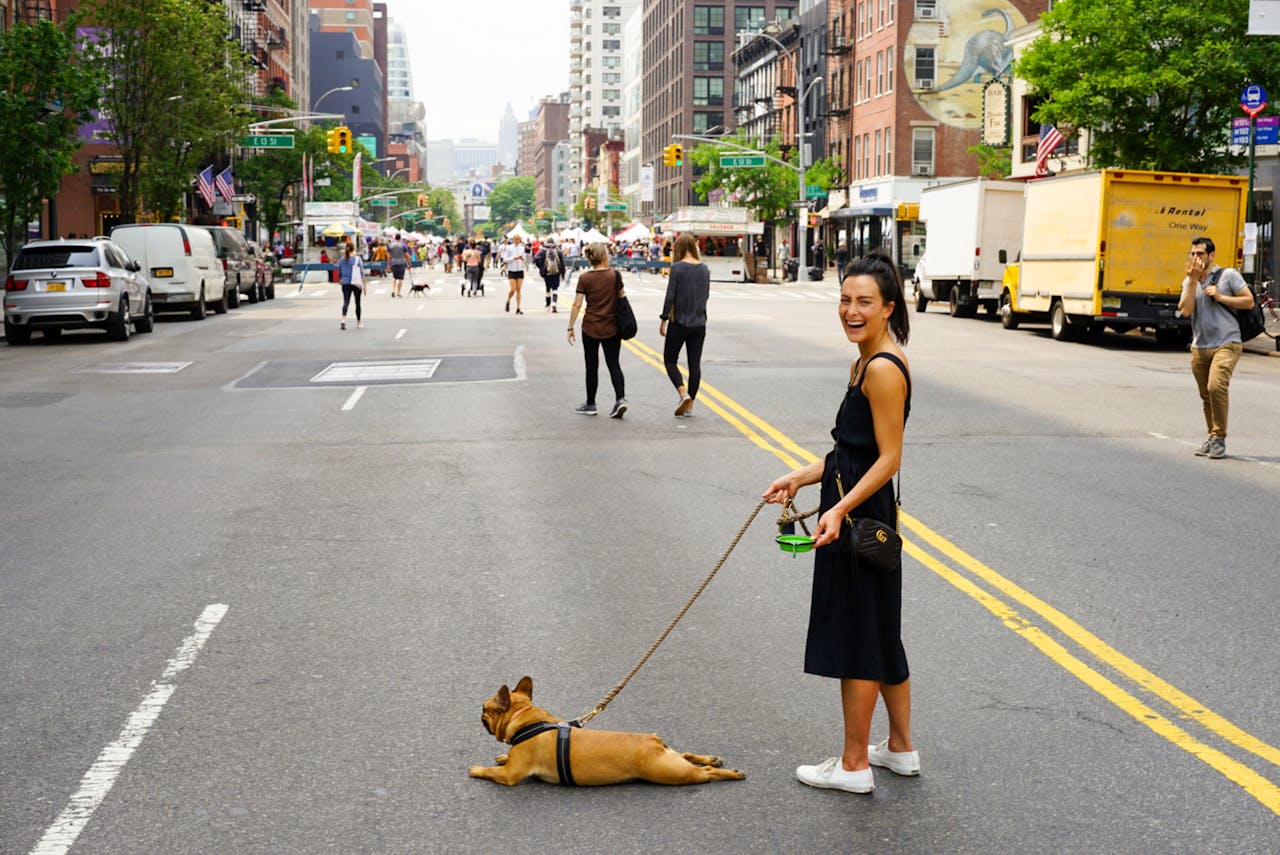woman with dog in the middle of the street