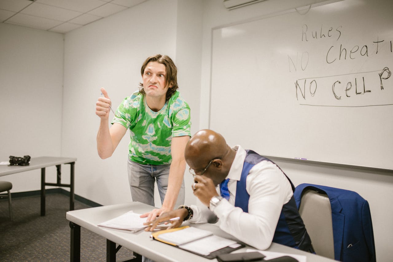 student signaling his clasmates to cheat during an exam