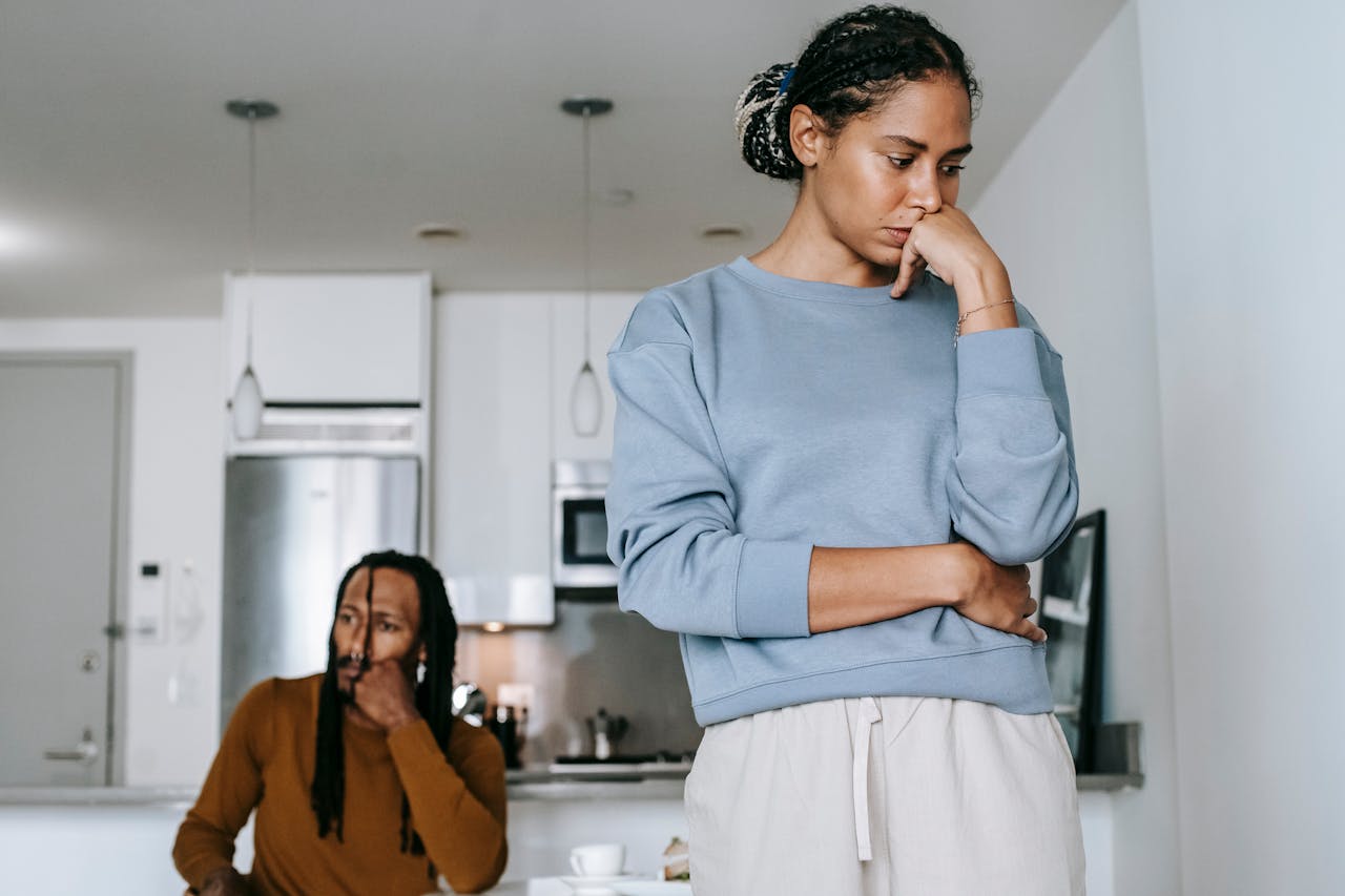offended black woman near pondering partner during quarrel at home