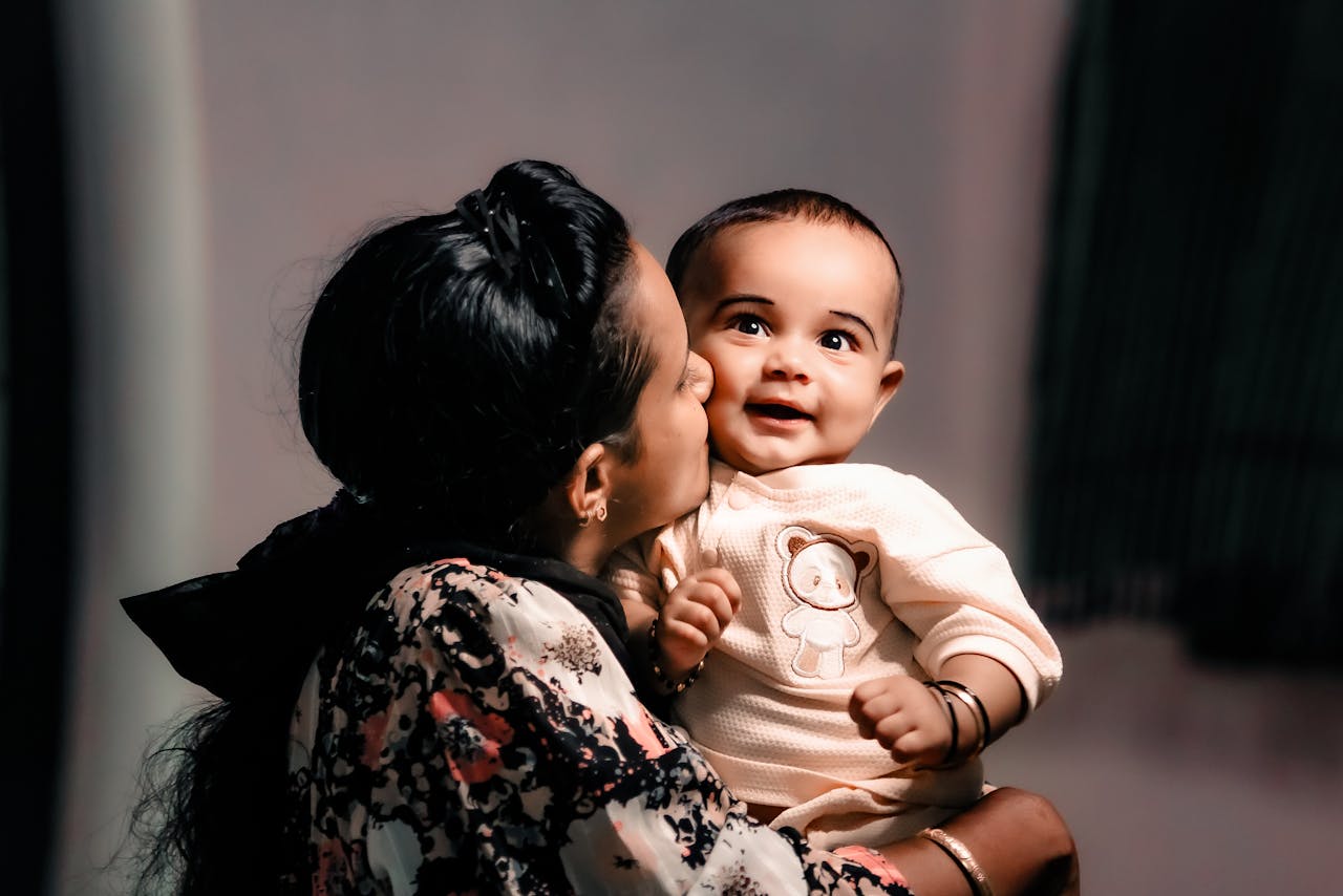 tender motherly kiss captured in warm portrait