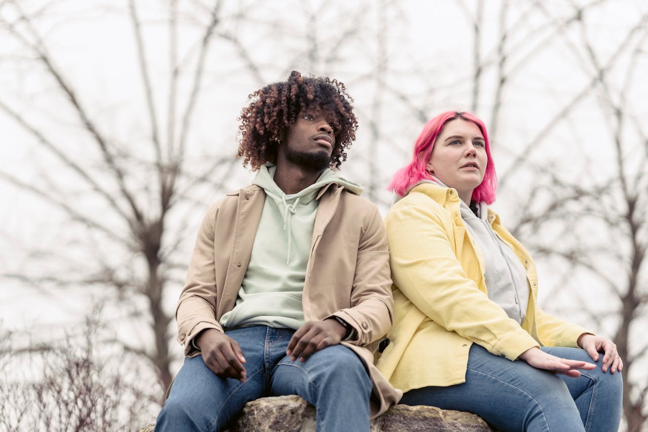 a couple sitting on a rock