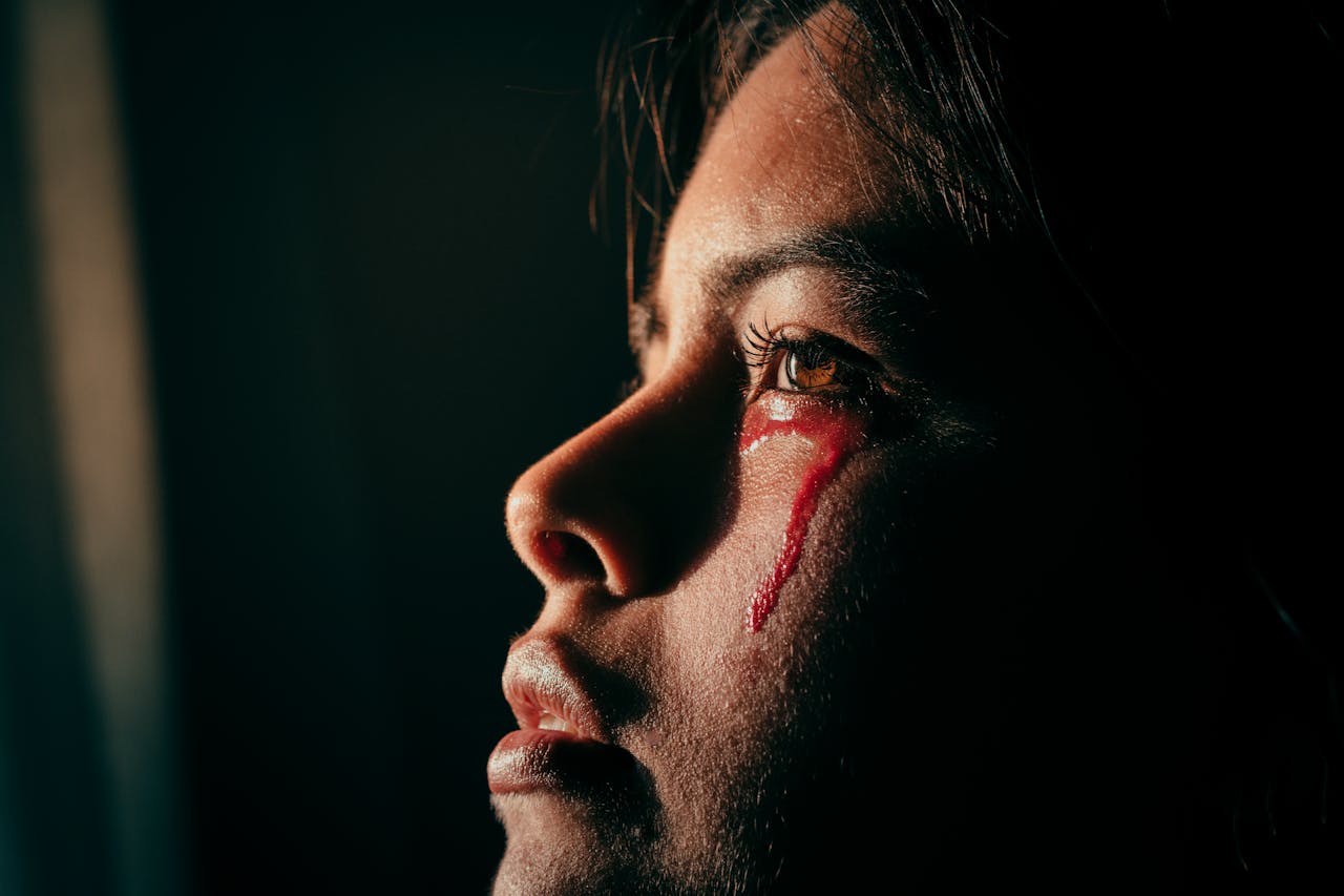 a woman tearing with blood
