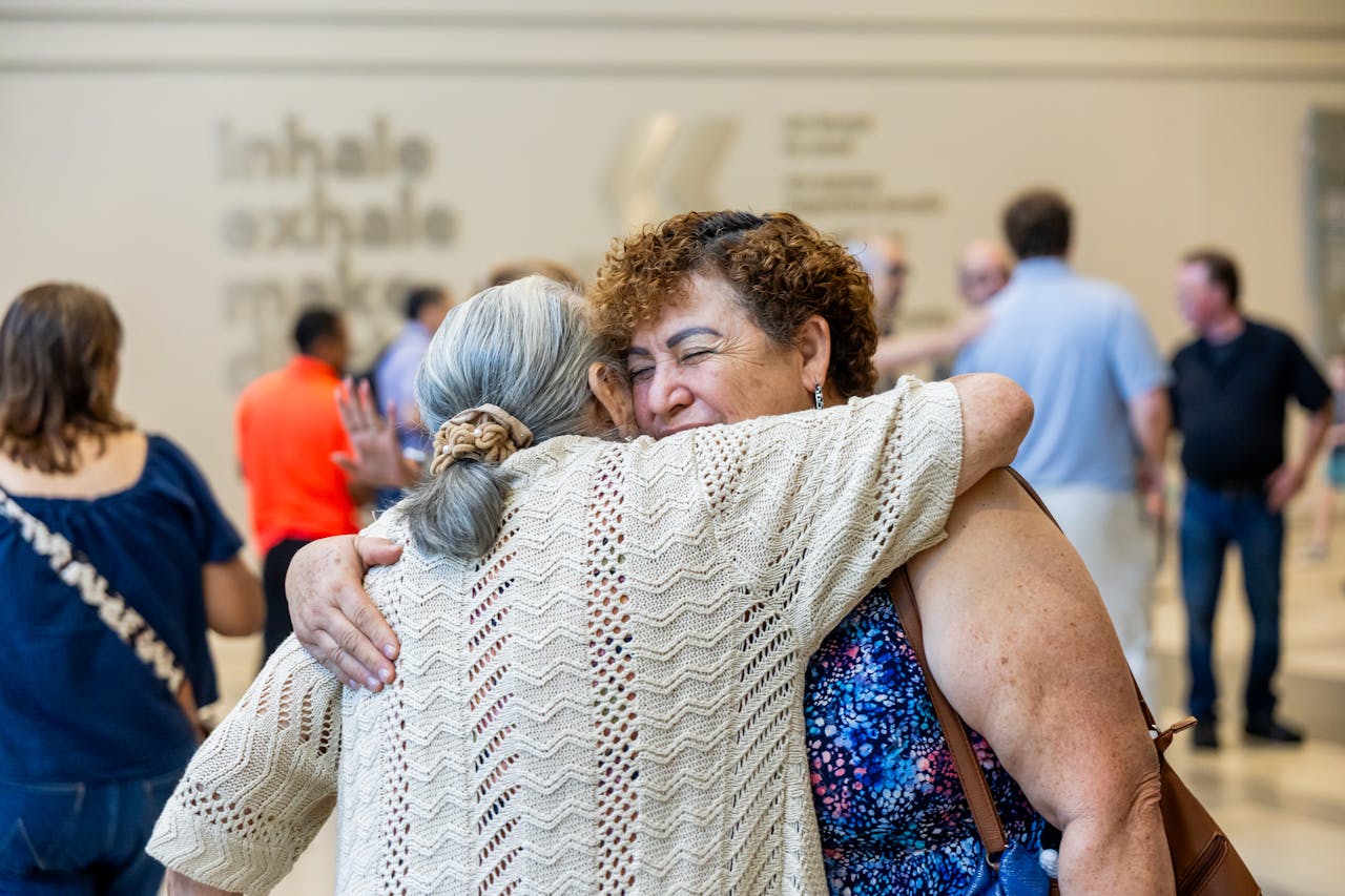 warm embrace beteween two senior women in public