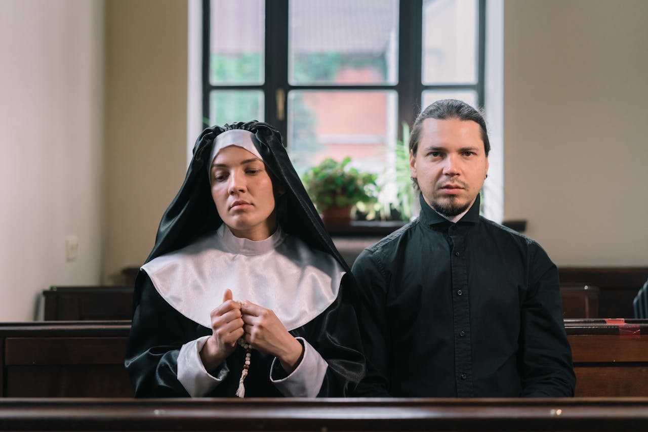 man in black thobe standing beside woman in white hijab