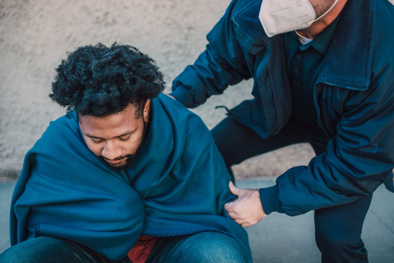 paramedic helping a man