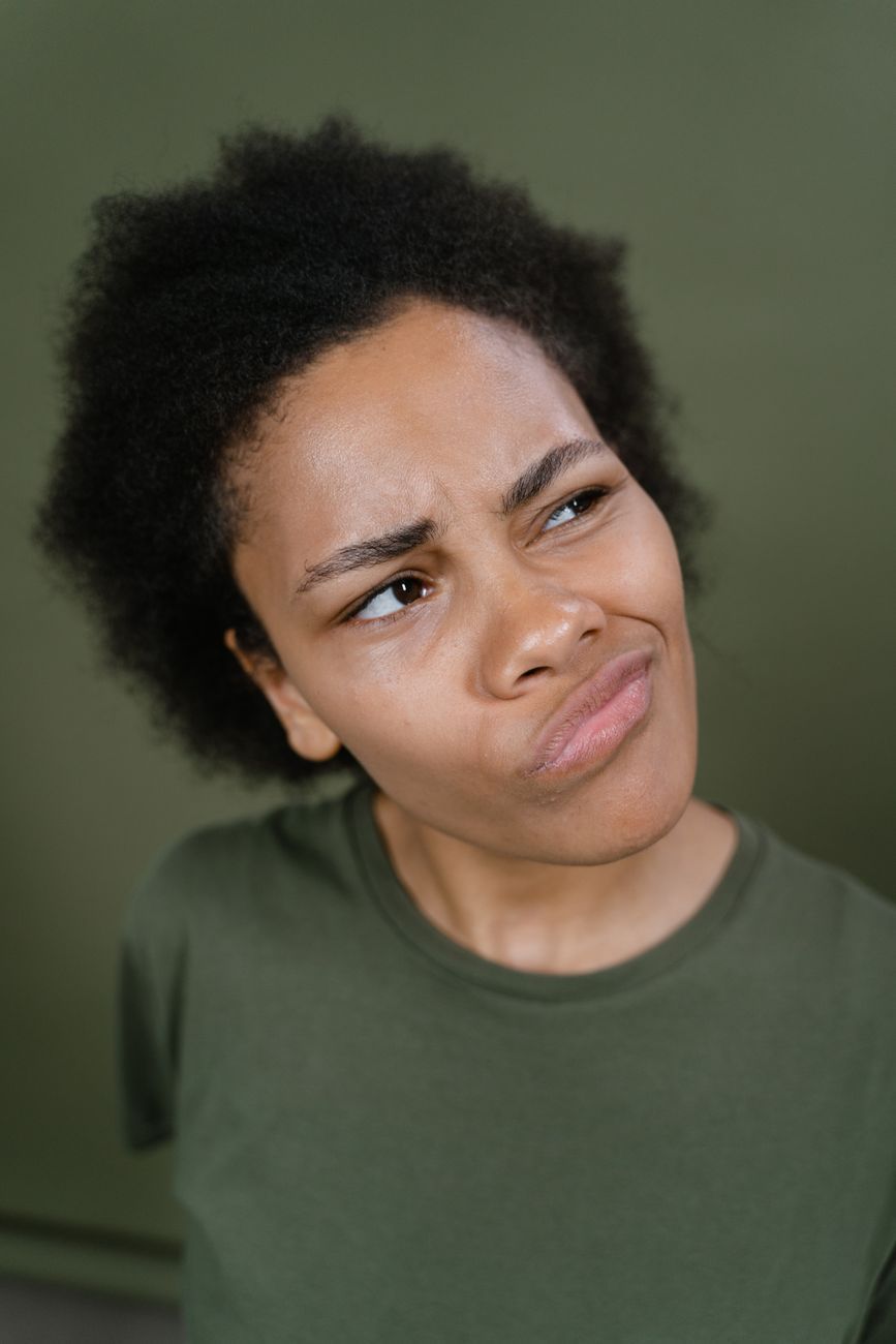 woman in green shirt thinking
