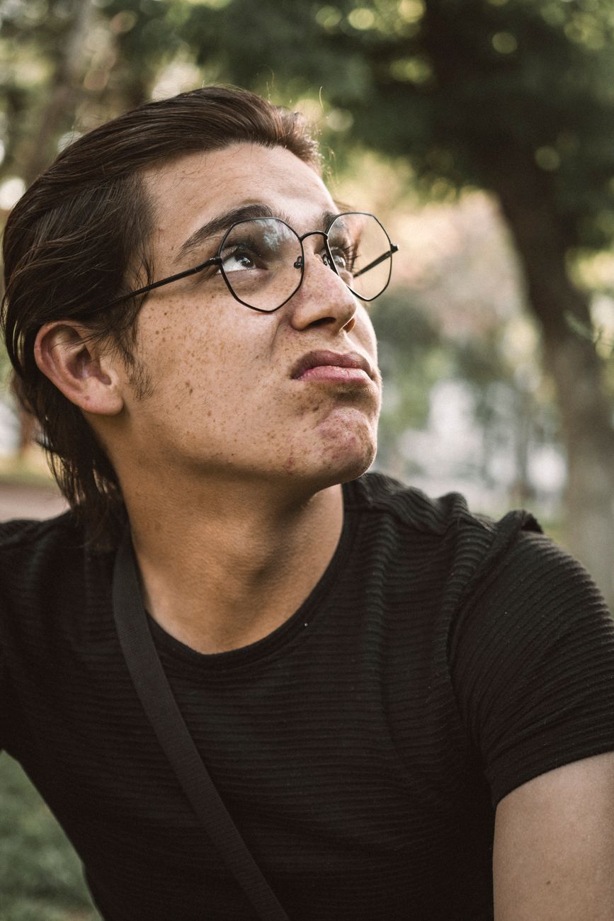 man wearing eyeglasses looking up