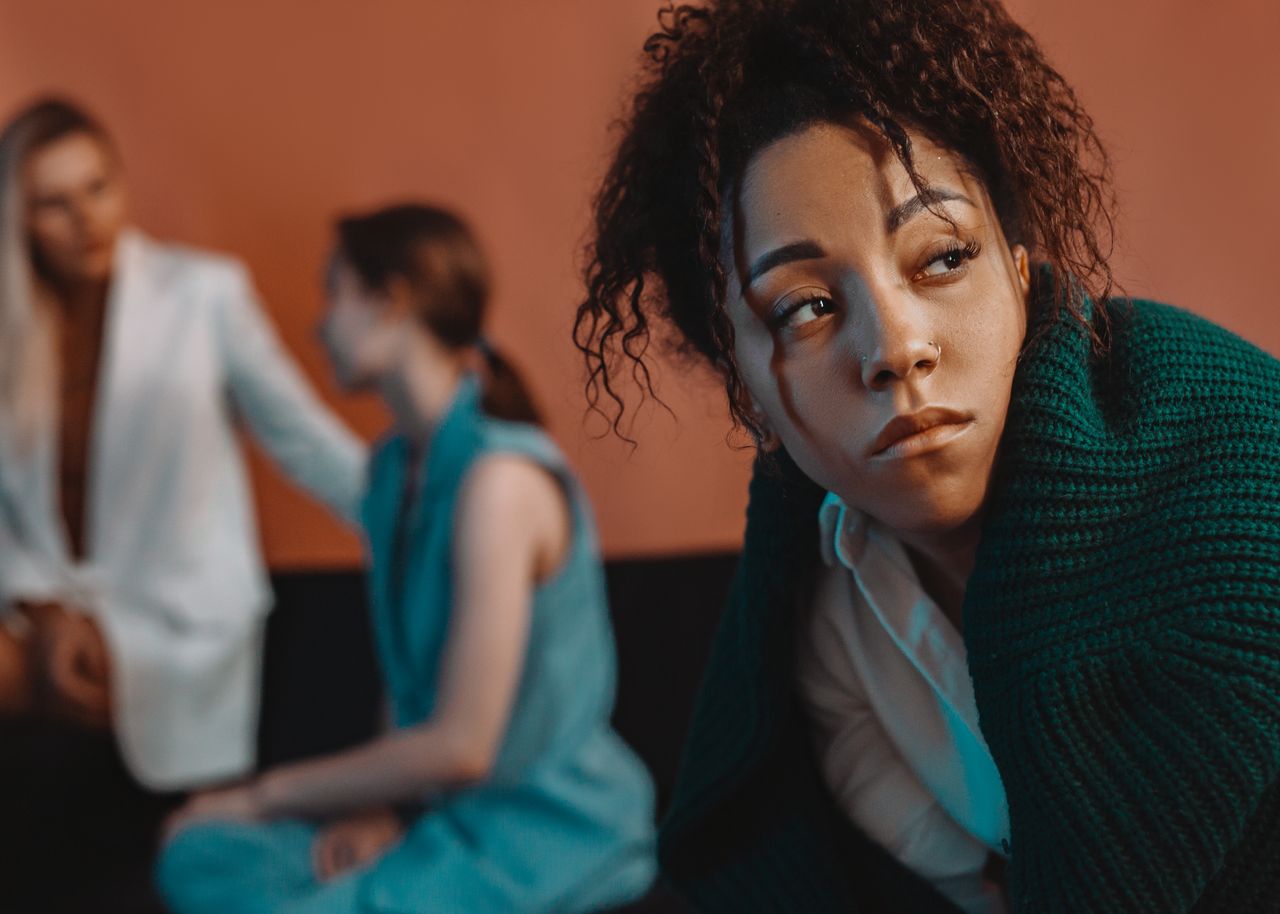 woman wrapped in a green knitted sweater